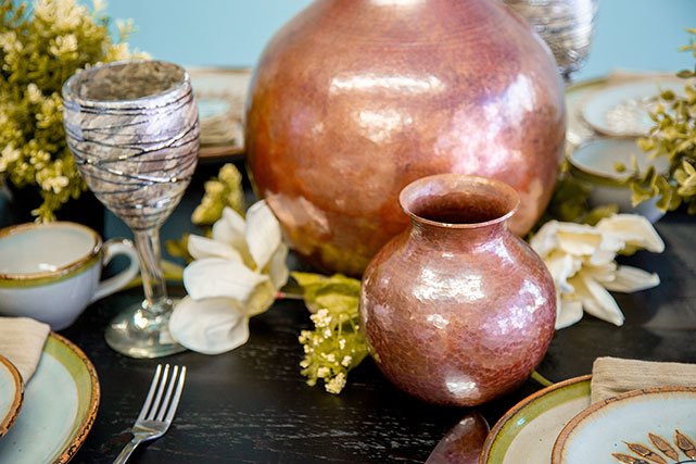 La Fuente Imports copper pots on table