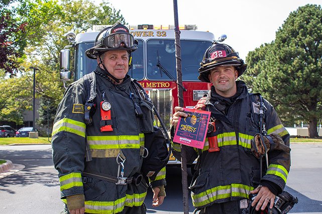 Perky Jerky being held by fire fighters