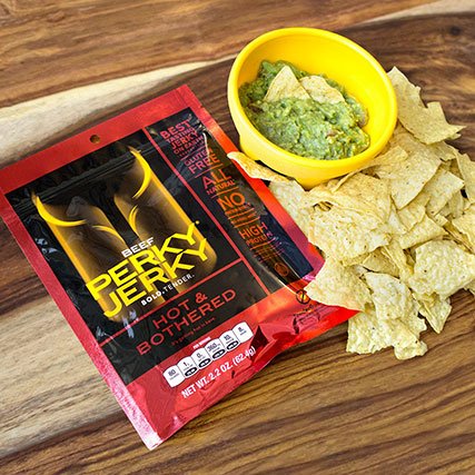 Perky Jerky next to chips and guacamole